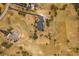 Expansive aerial view of a home and its large, grassy property with a long driveway and mature trees at 3639 Pine Meadow Ave, Parker, CO 80138