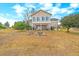 Large backyard featuring an outdoor seating area, covered patio, and a charming fire pit at 3639 Pine Meadow Ave, Parker, CO 80138