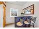 Stylish bar area with seating, decorated with an oversized beer advertisement mirror and ample natural light at 3639 Pine Meadow Ave, Parker, CO 80138