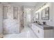 Modern bathroom features stone accent wall, glass shower, and double vanity at 3639 Pine Meadow Ave, Parker, CO 80138