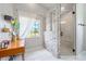 A bright bathroom showcasing a stone accent wall, glass-enclosed shower, and modern vanity at 3639 Pine Meadow Ave, Parker, CO 80138