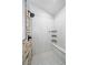 A modern bathroom with a tiled shower and bench, featuring sleek fixtures and a stone accent wall at 3639 Pine Meadow Ave, Parker, CO 80138