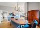 Open-concept dining room with hardwood floors, modern lighting, and adjacent living spaces at 3639 Pine Meadow Ave, Parker, CO 80138