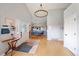 Welcoming entryway with hardwood floors, modern decor, and views into dining area at 3639 Pine Meadow Ave, Parker, CO 80138