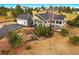 Elevated view of the home with a spacious back deck, mature landscaping, and a two-car garage at 3639 Pine Meadow Ave, Parker, CO 80138