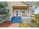 Inviting front porch with blue stairs and white railings welcomes guests to this charming home at 3639 Pine Meadow Ave, Parker, CO 80138