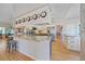 An open concept kitchen features a large island, light wood flooring and stainless steel appliances at 3639 Pine Meadow Ave, Parker, CO 80138