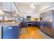 A kitchen featuring two-tone cabinetry, stainless appliances, hardwood floors and granite countertops at 3639 Pine Meadow Ave, Parker, CO 80138