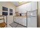 Well-organized kitchenette area with white cabinetry, butcher block countertop, and modern appliances at 3639 Pine Meadow Ave, Parker, CO 80138