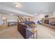 Open living room features stairs, a cozy fireplace, plush sofa, and table for entertaining at 3639 Pine Meadow Ave, Parker, CO 80138