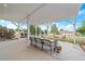 A covered patio that offers a comfortable outdoor seating area with a view of the landscape at 3639 Pine Meadow Ave, Parker, CO 80138