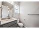 Bright bathroom features an undermount sink, modern vanity, and shower with glass door at 2464 Wesley Ln, Lafayette, CO 80026