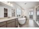 Large primary bathroom with double sinks, soaking tub and glass enclosed shower at 2464 Wesley Ln, Lafayette, CO 80026