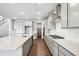 Well-lit kitchen featuring an island, pantry, stainless steel appliances, and hardwood floors at 2464 Wesley Ln, Lafayette, CO 80026