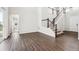 Bright and airy living room with hardwood floors, staircase, and white walls at 2464 Wesley Ln, Lafayette, CO 80026