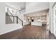 Open-concept living space with staircase and kitchen, featuring hardwood floors and modern finishes at 2464 Wesley Ln, Lafayette, CO 80026