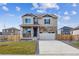 Charming two-story home with stone accents, a two-car garage, and a well-manicured lawn at 27404 E Byers Ave, Aurora, CO 80018