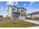 Beautiful two-story home featuring a stone facade, a two-car garage and a landscaped front yard at 27404 E Byers Ave, Aurora, CO 80018