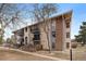 Multi-Gathering building with balconies and partial brick facade on a sunny day at 12143 Melody Dr # 103, Denver, CO 80234