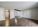 Open concept living area with hardwood floors, and access to kitchen and hallway at 12143 Melody Dr # 103, Denver, CO 80234