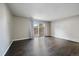 Bright and airy living room with hardwood floors and sliding door to the outdoors at 12143 Melody Dr # 103, Denver, CO 80234