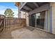 Small patio with wood fence and sliding glass doors to the house at 12143 Melody Dr # 103, Denver, CO 80234