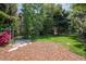 Serene backyard with lush greenery and a stone pathway, creating a tranquil outdoor escape at 2675 Timberchase Trl, Highlands Ranch, CO 80126