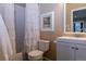 Small bathroom with a toilet, tub, and white vanity at 2675 Timberchase Trl, Highlands Ranch, CO 80126