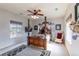 Cozy bedroom with wooden four-poster bed and ceiling fan at 2675 Timberchase Trl, Highlands Ranch, CO 80126