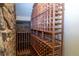 Unique wine cellar featuring wooden shelving and stone accents for the wine enthusiast at 2675 Timberchase Trl, Highlands Ranch, CO 80126