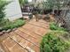 Backyard with patterned tile area, wood decking, and lush greenery, offering a tranquil outdoor space at 2758 S Salida St, Aurora, CO 80013