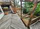 Wooden deck with pergola and stair access to a landscaped backyard with a charming rock feature at 2758 S Salida St, Aurora, CO 80013