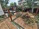 Backyard featuring a wood deck, greenery, and partially constructed structure, ideal for relaxation at 2758 S Salida St, Aurora, CO 80013