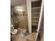 Bathroom featuring tiled floors, glass enclosed shower and storage closet at 2758 S Salida St, Aurora, CO 80013