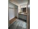 View of a bathroom vanity with mirror, lighting, and an adjacent closet at 2758 S Salida St, Aurora, CO 80013