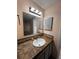 Bathroom vanity with mirror, lighting, and a neutral color palette at 2758 S Salida St, Aurora, CO 80013