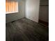 This bedroom features modern, gray wood flooring and a window providing natural light at 2758 S Salida St, Aurora, CO 80013