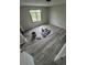 Bright bedroom featuring gray wood flooring and a window overlooking the outdoor scenery at 2758 S Salida St, Aurora, CO 80013