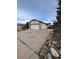 Charming home featuring a two-car garage with a long driveway and stone accents at 2758 S Salida St, Aurora, CO 80013