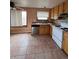 Well-lit kitchen with stainless steel dishwasher and tile flooring at 2758 S Salida St, Aurora, CO 80013