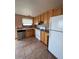 Traditional kitchen featuring wood cabinets and white appliances at 2758 S Salida St, Aurora, CO 80013