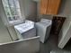 Bright laundry area with side-by-side washer and dryer units and natural light, needs renovations at 2758 S Salida St, Aurora, CO 80013