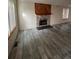 Cozy living room featuring modern floors, a brick fireplace, and many windows at 2758 S Salida St, Aurora, CO 80013