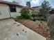 Side yard with mulched garden, flowering bushes, and a concrete area for outdoor enjoyment at 2758 S Salida St, Aurora, CO 80013