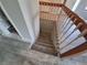 Stairway to lower level of home with wood railing and carpeted stairs at 2758 S Salida St, Aurora, CO 80013