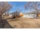 A large, well-maintained backyard great for recreation, featuring a wooden deck and detached garage at 1350 Valentia St, Denver, CO 80220