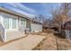 Backyard view of the house, featuring patio and well-maintained lawn at 1350 Valentia St, Denver, CO 80220