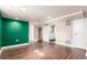 A finished basement featuring a modern color scheme, recessed lighting and wood-look flooring at 1350 Valentia St, Denver, CO 80220