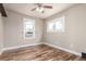 A cozy bedroom featuring hardwood floors, a ceiling fan and two windows for ample natural light at 1350 Valentia St, Denver, CO 80220