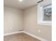 A cozy bedroom featuring hardwood floors, neutral walls, and a window for natural light at 1350 Valentia St, Denver, CO 80220